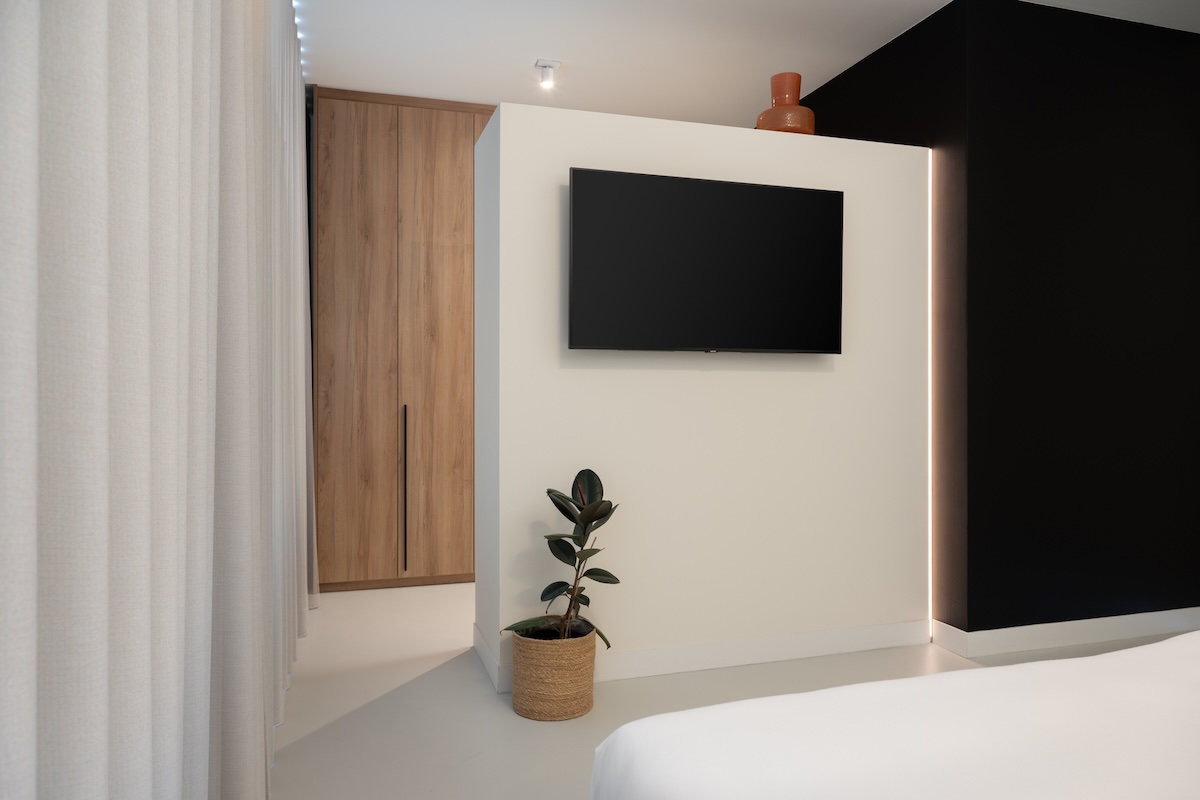 Industriële slaapkamer met houten bed en inloopkast